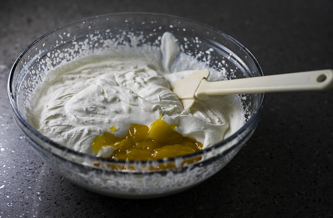 whipped cream in a bowl with lemon curd