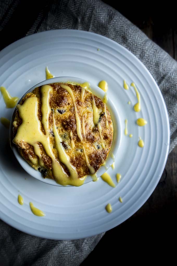 cheese souffle in a ramekin drizzled with hollandaise