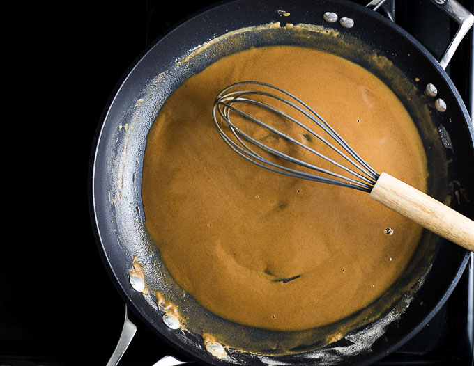 blond roux being mixed in a skillet