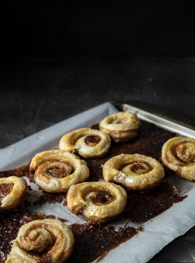 cinnamon pastries on a baking sheet lined with parchment paper