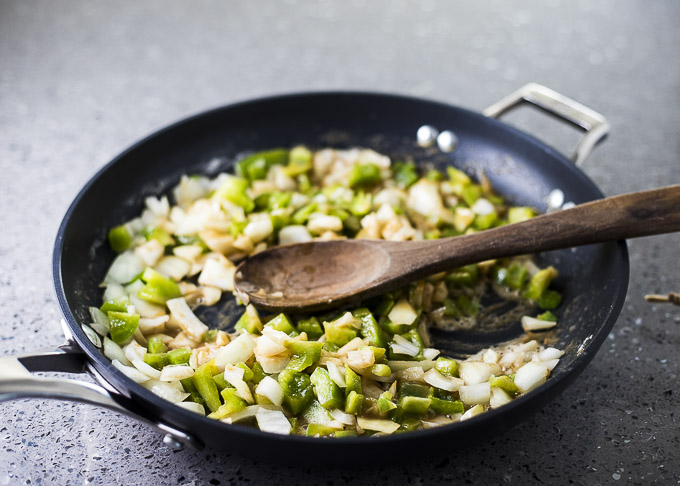 green peppers and onions in a skillet