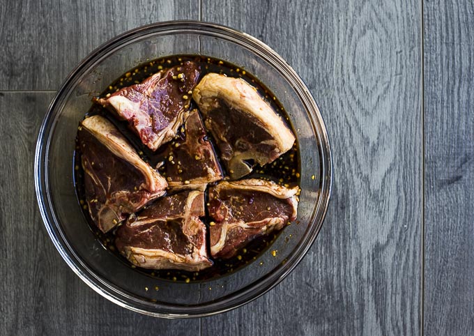 lamb chops in a bowl with marinade