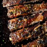 sliced bbq pork spare ribs on a platter