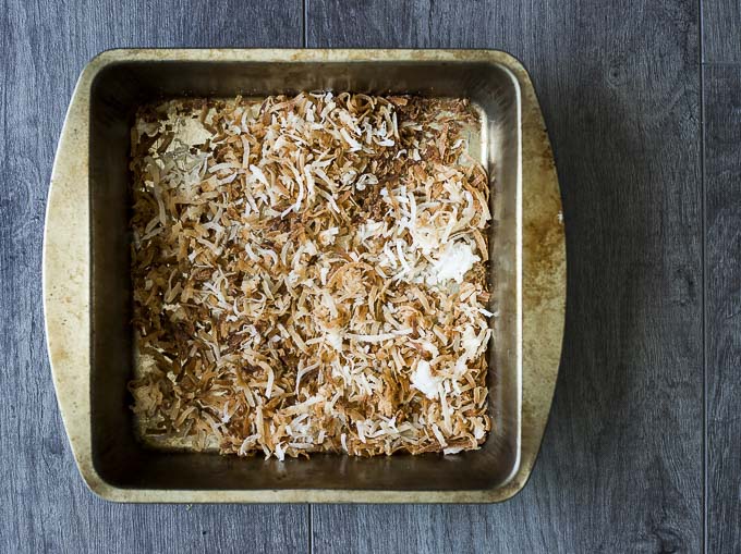 toasted coconut in a metal baking dish