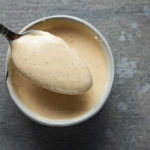a spoonful of orange creamy sauce