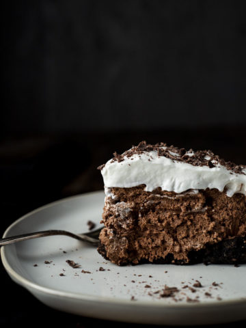side view of a piece of chocolate mousse pie with whipped cream