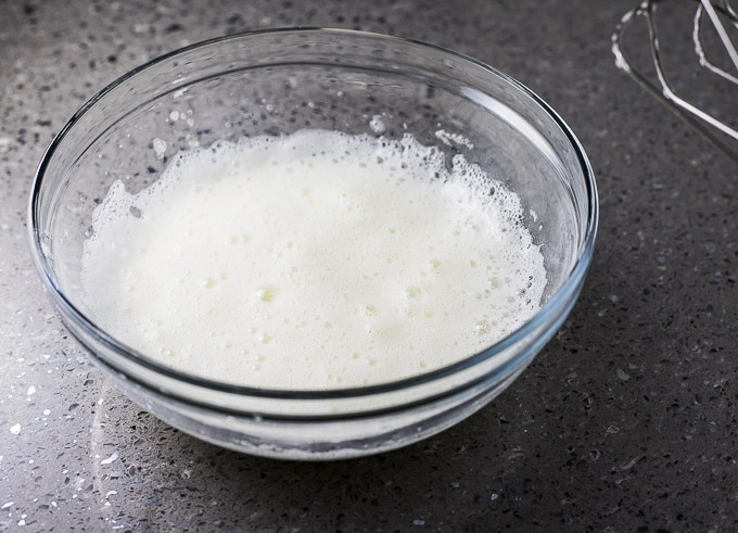 frothy egg whites in a bowl