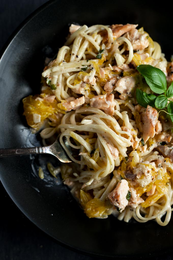 pasta with salmon and orange pieces with twirl of pasta on a fork