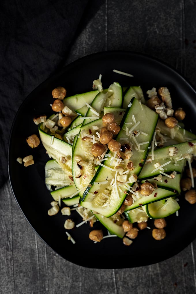 zucchini salad with chickpeas and parmesan cheese on a plate