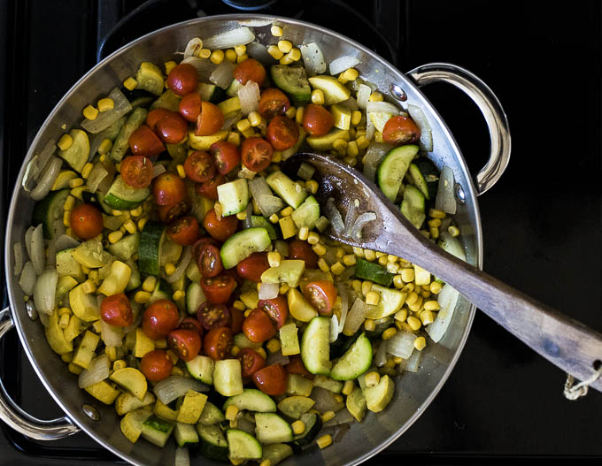 squash, corn and tomatoes in a skillet