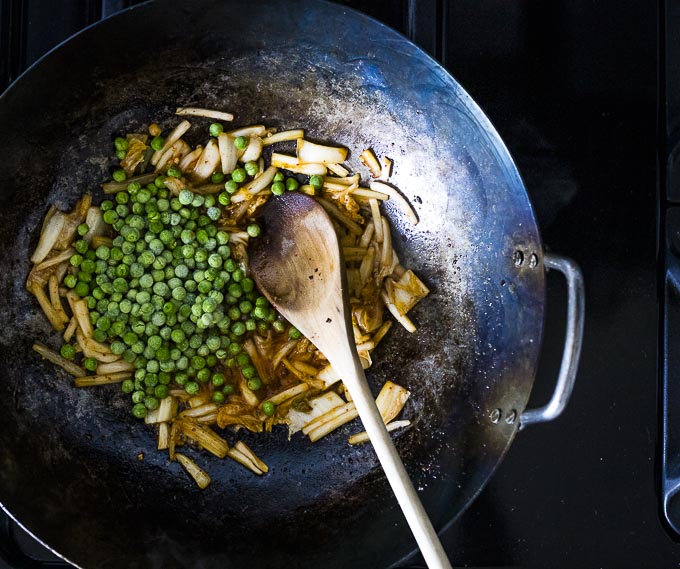 kimchi and peas in a wok