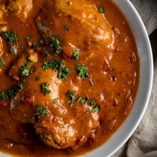 chicken in orange sauce with parsley on top