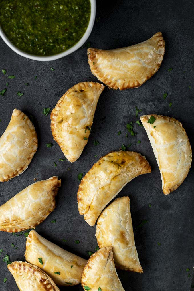 empanadas with chimichurri sauce on the side