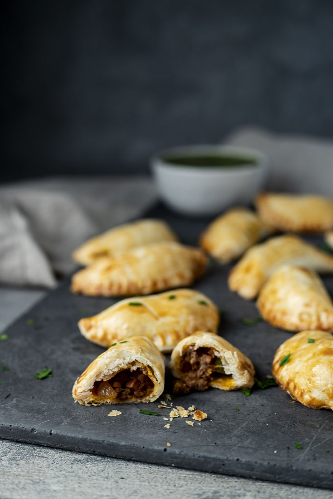 an empanada cut down the middle on a platter