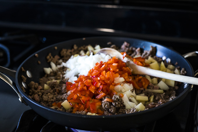 ground beef and red peppers in a skillet