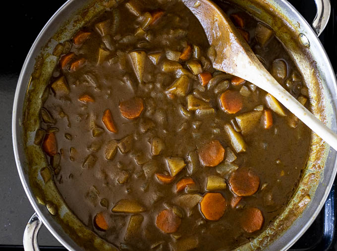 curry gravy with carrots and potatoes in a pan