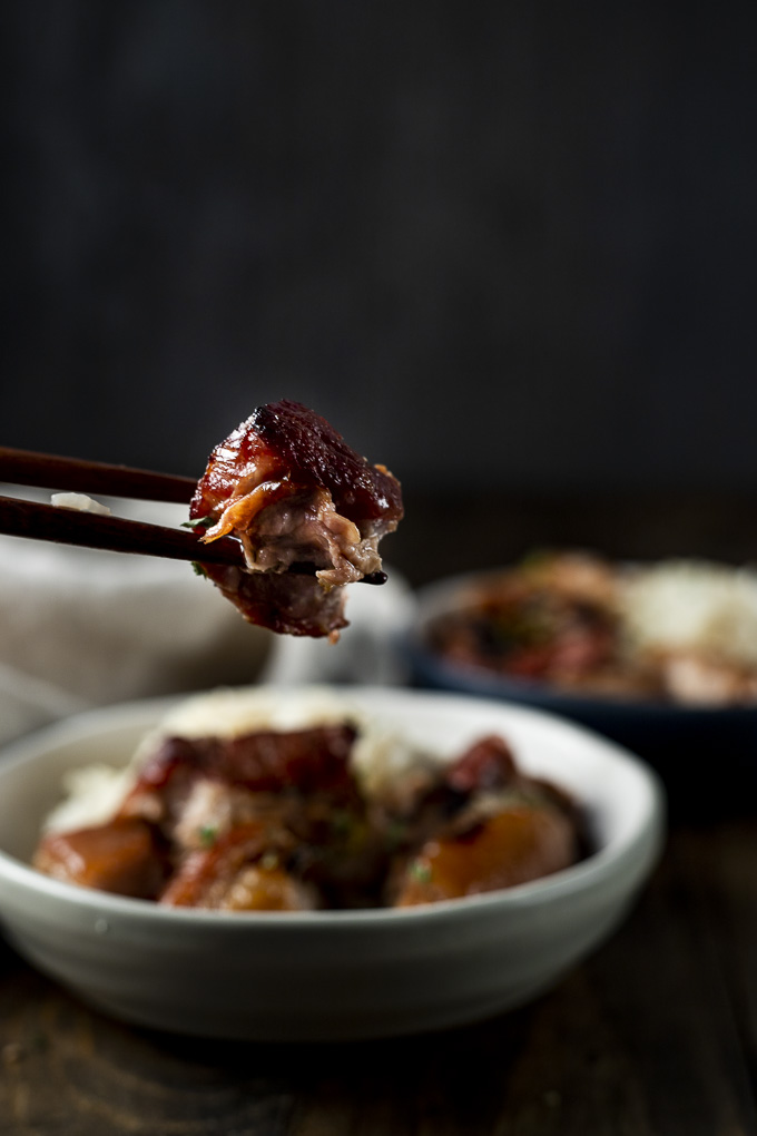 piece of pork belly in chopsticks