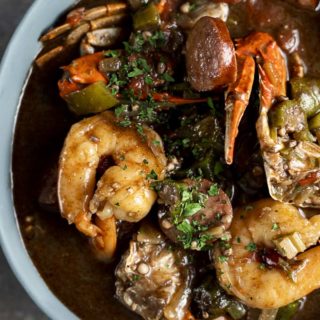 a bowl of gumbo with crab, shrimp, sausage and vegeatbles