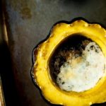 roasted acorn squash half with melted butter in middle