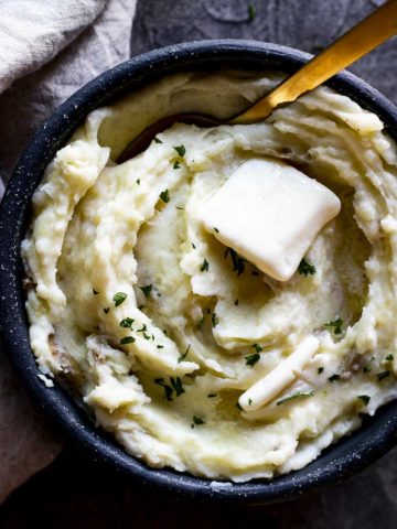 bowl of mashed potatoes with butter and a spoon