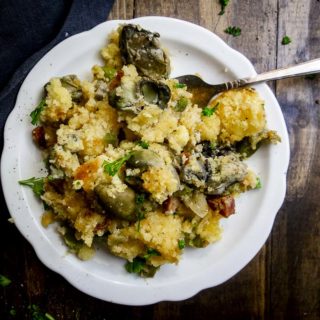oyster cornbread stuffing on a plate with a fork