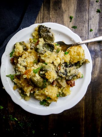 oyster cornbread stuffing on a plate with a fork