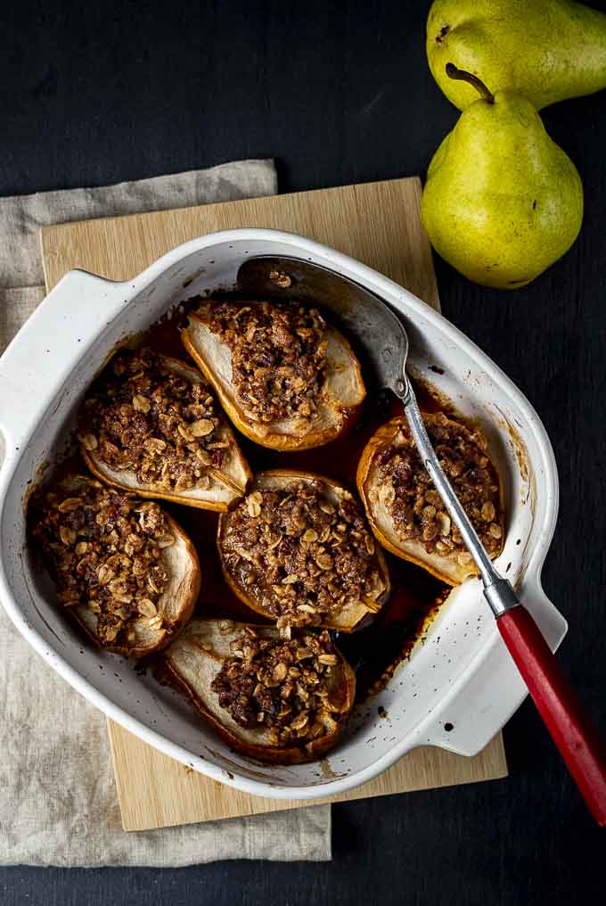 pear crisp in a baking dish with a spoon