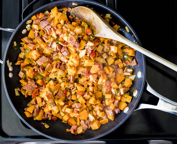 sweet potatoes and vegetables cooked in a skillet