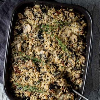 wild rice stuffing in a baking dish with fresh thyme