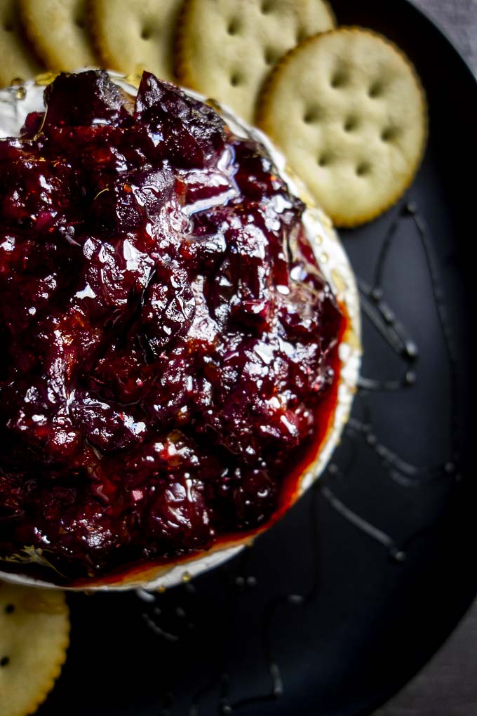 cranberry sauce on a round of brie cheese
