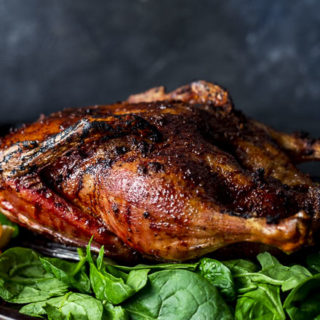 side view of a crispy roasted duck