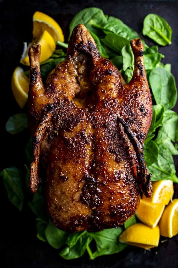 whole roasted duck on a platter