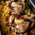 roasted cornish game hen in a baking dish