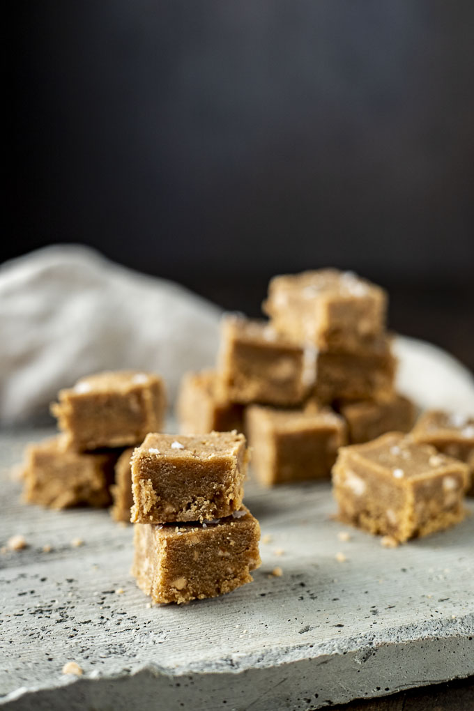 stacked squares of peanut butter fudge on concrete
