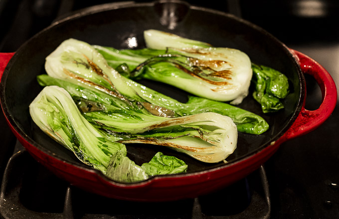 sauteed baby bok choy in a skillet
