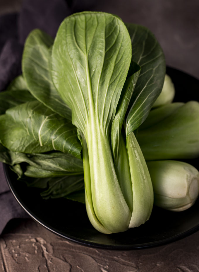 raw baby bok choy on a plate