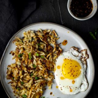 crispy hash browns with an egg and green onions