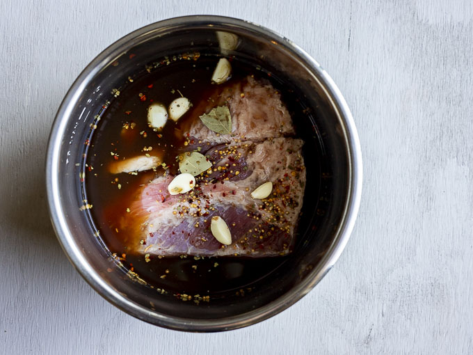 corned beef in a pot with seasonings and broth