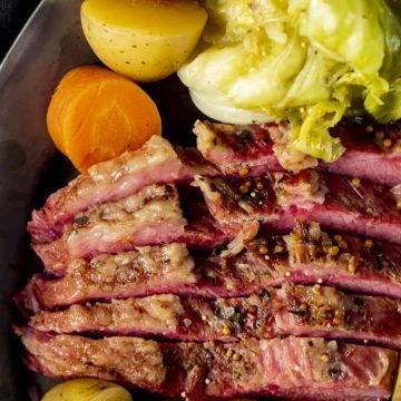 corned beef with cabbage, carrots and potatoes on the side