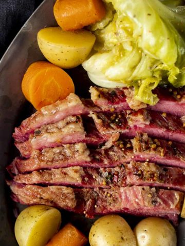 corned beef with cabbage, carrots and potatoes on the side