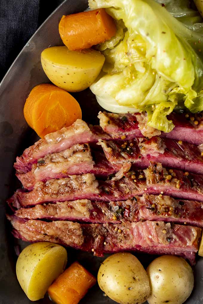 corned beef with cabbage, carrots and potatoes on the side