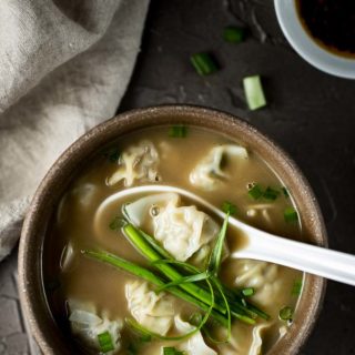 bowl of wonton soup with soup spoon