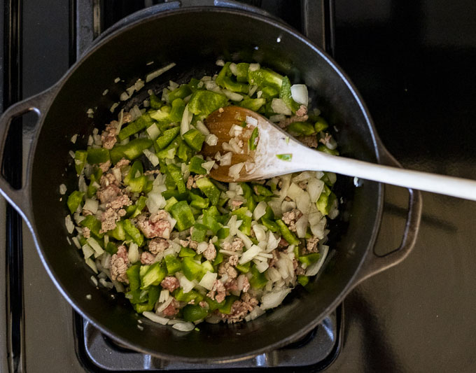 pork, onions and green peppers in a pot