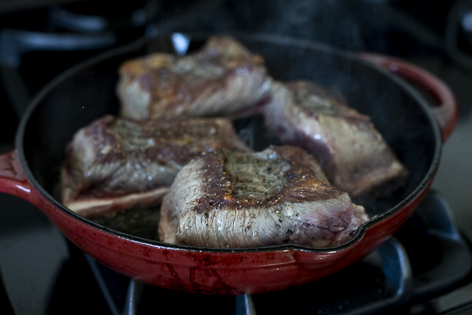short ribs being browned in a skillet