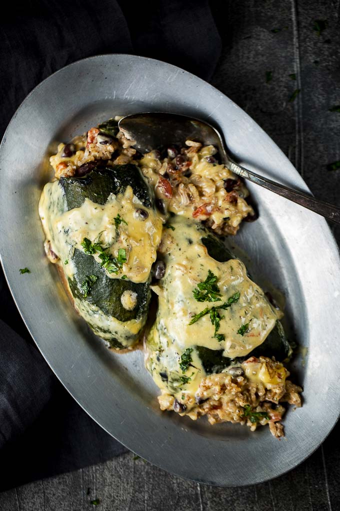 2 baked poblano peppers on a plate with stuffing