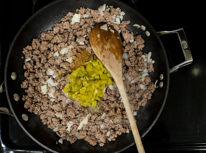 ground beef with green chilies in a skillet