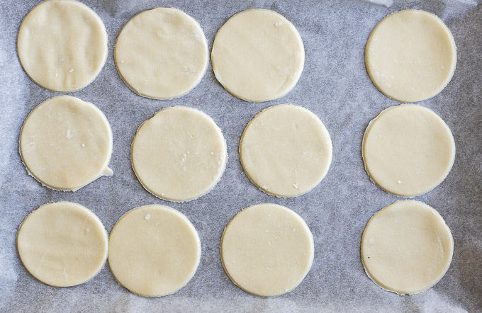 rounds of pie crust on parchment paper