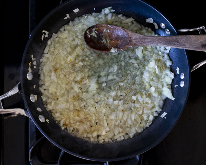 onions and liquid cooking in a skillet