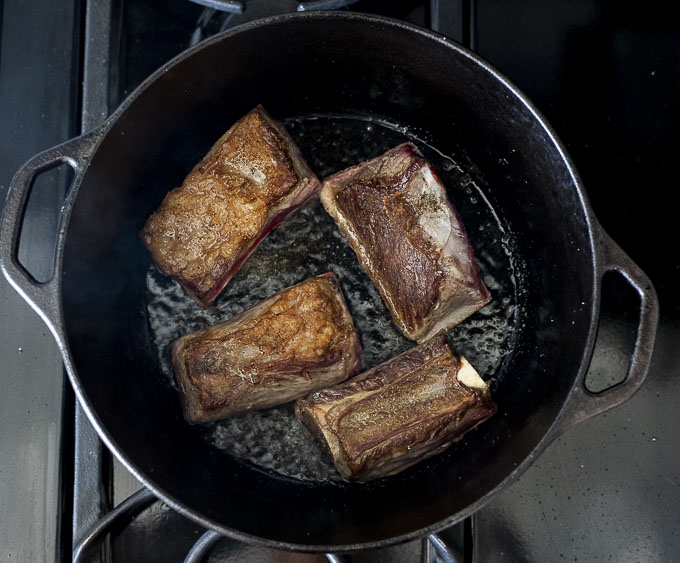 beef short ribs browning in a pot