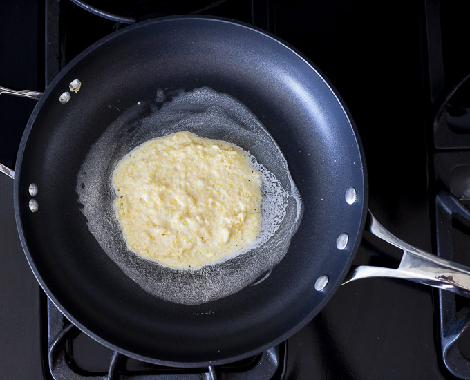cornmeal pancake batter in a skillet